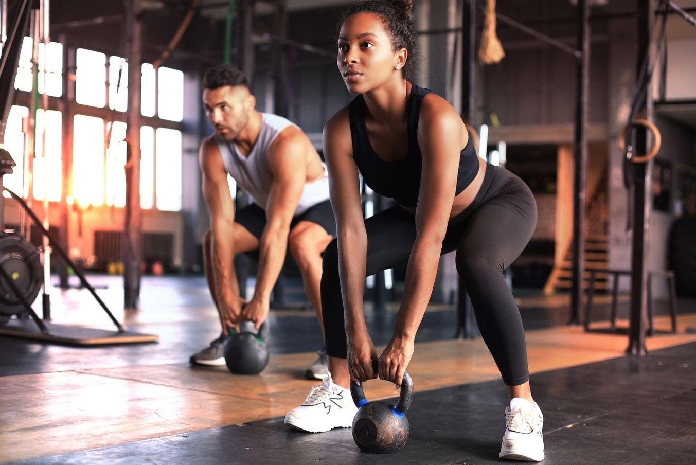 woman and man working out in gym