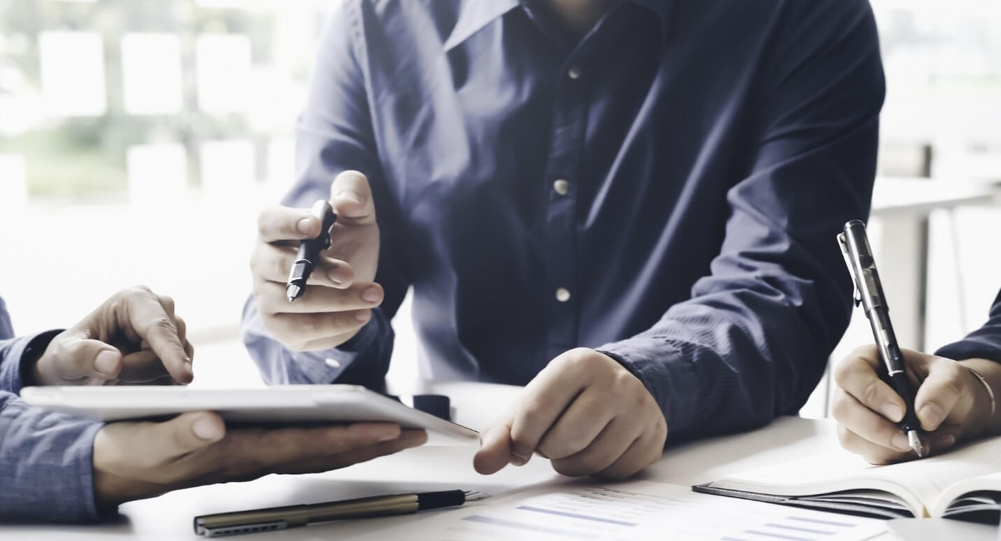 man writing at desk