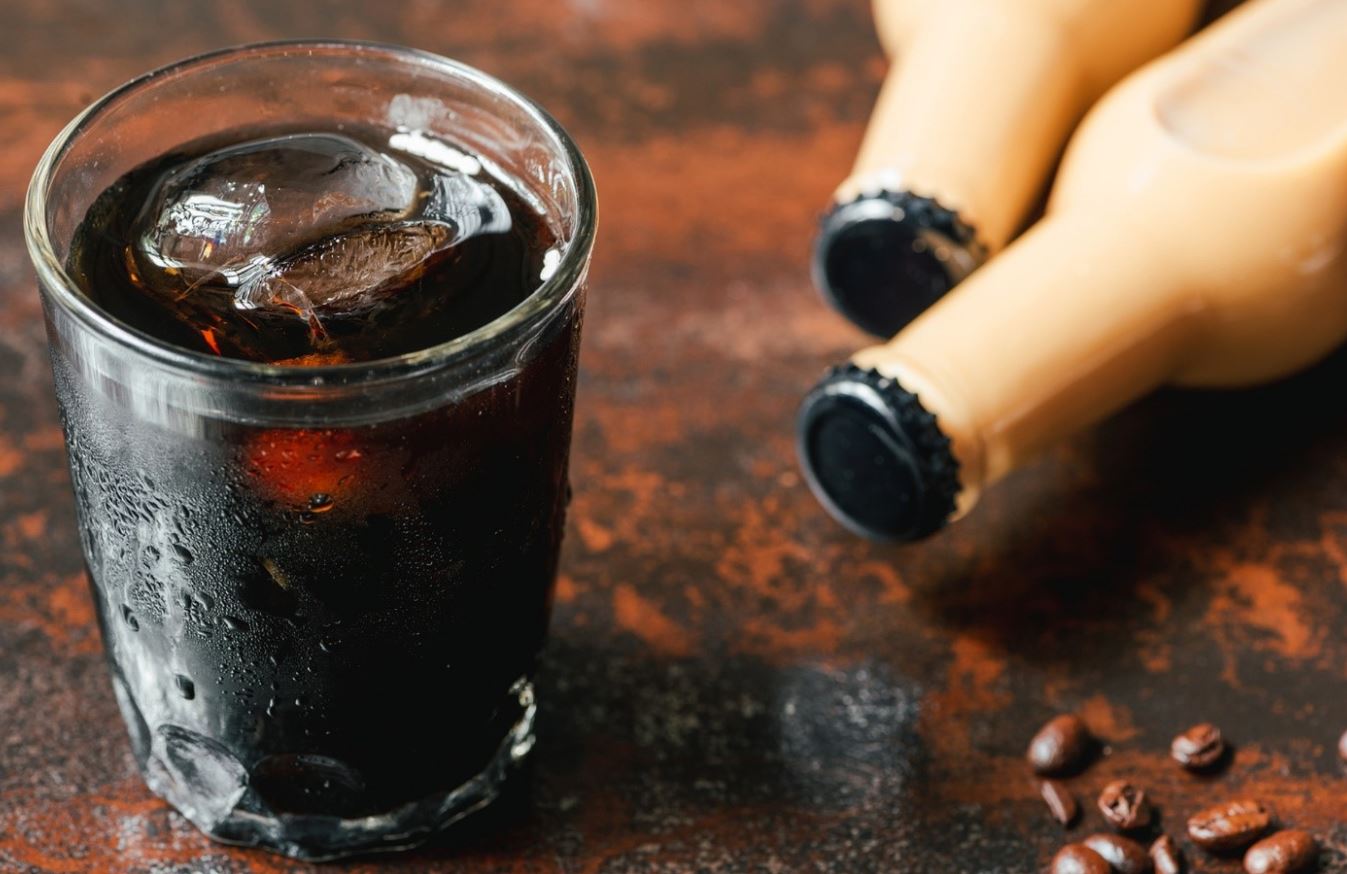 functional beverage in glass with ice and bottles