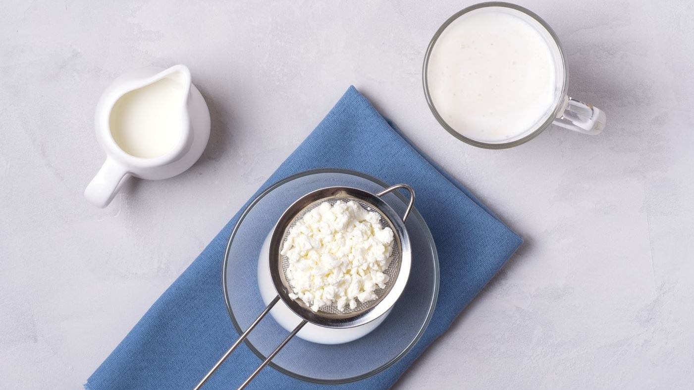 kefir grains milk jug and glass on table