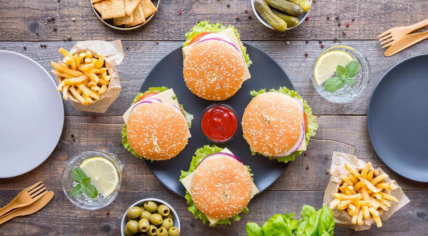 plant-based burgers on table with sides