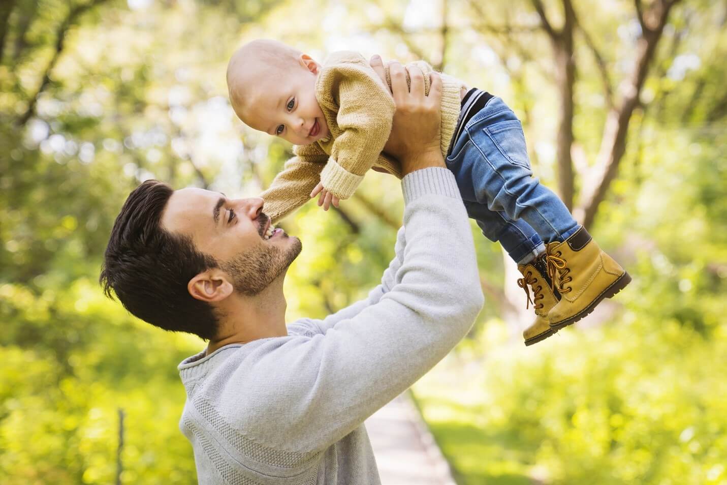 dad raising baby in the air