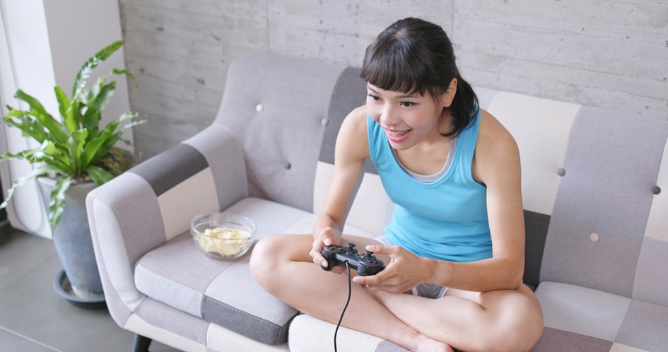 Woman playing video games on the couch
