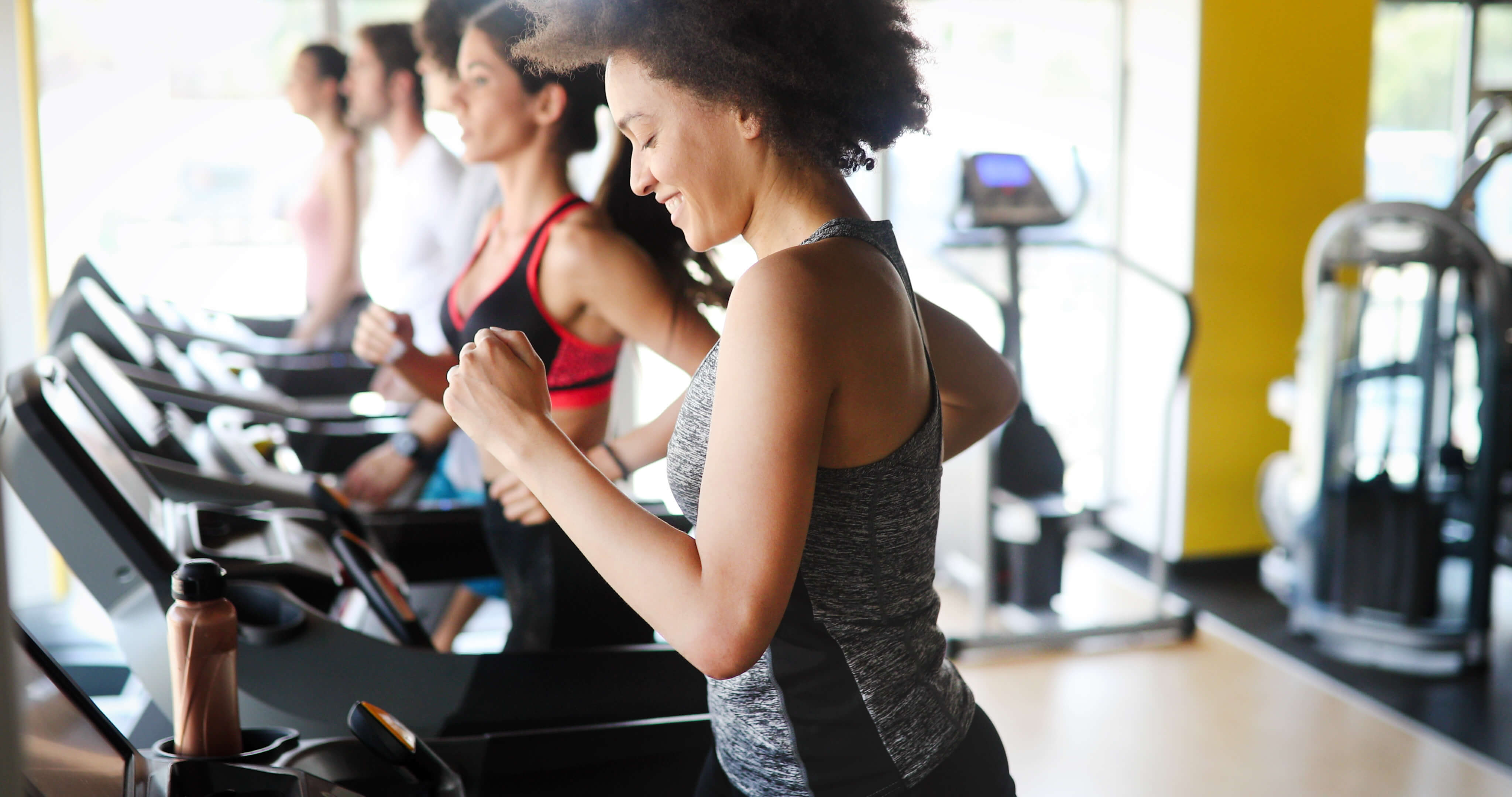 woman smiling on workout machine