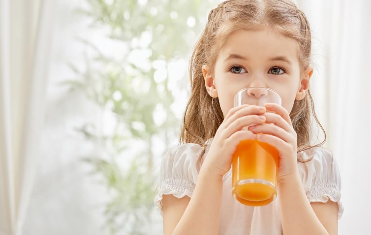 little girl drinking juice