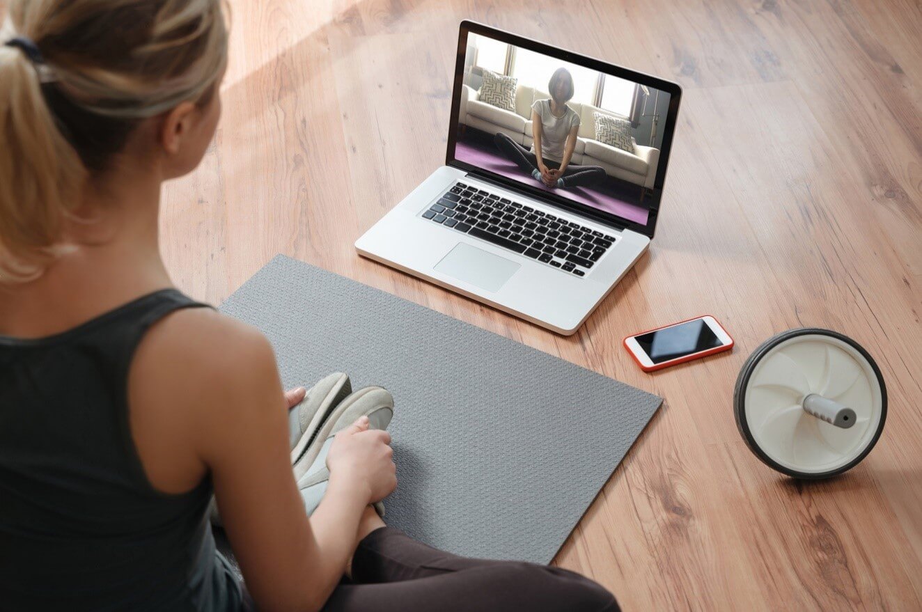 woman on yoga mat doing home workout