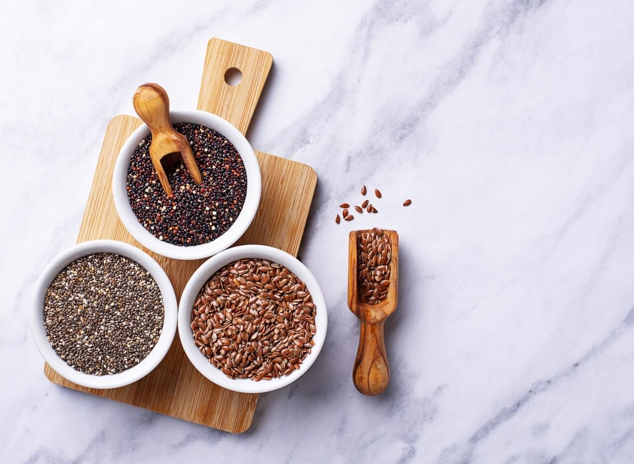 three bowls of seeds on table