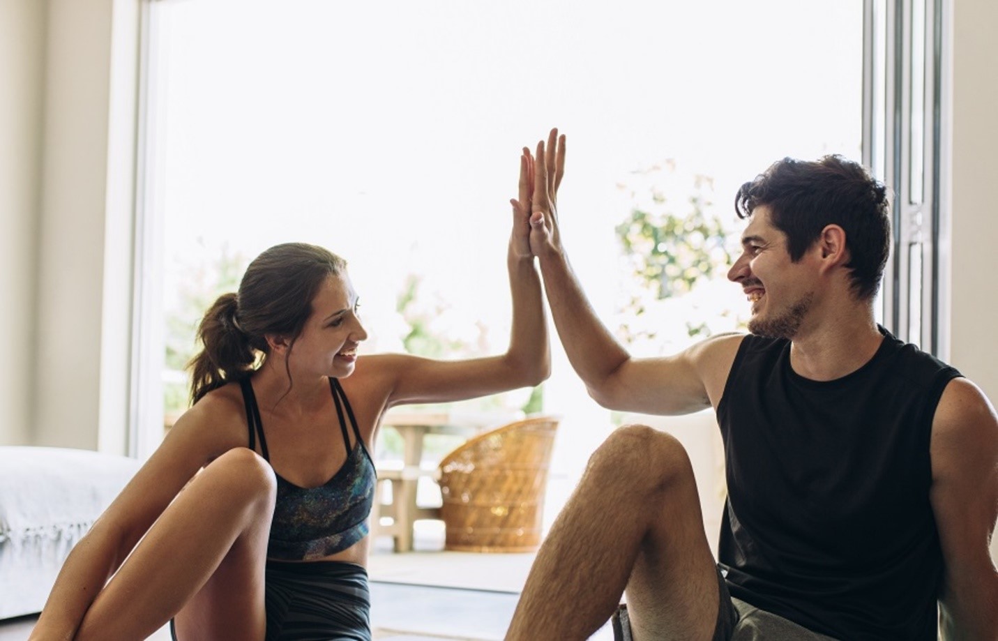 man and woman high fiving