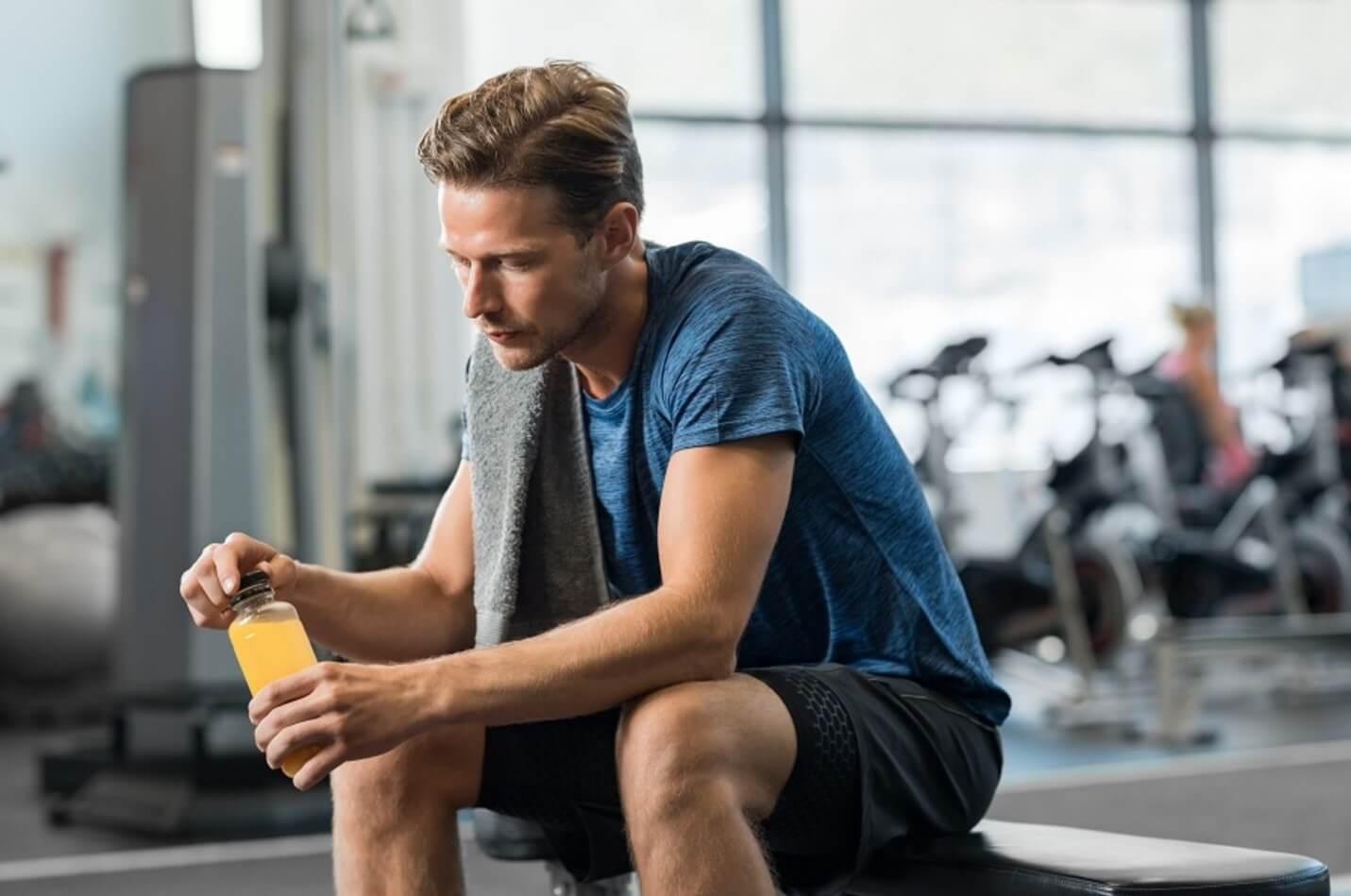 man holding drink at gym