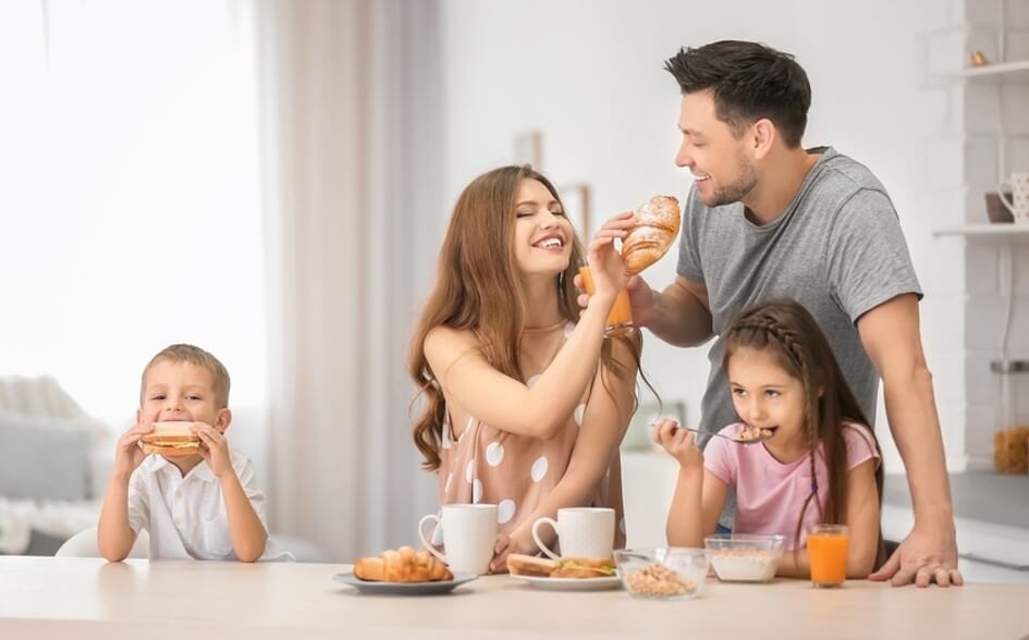 mom and dad with two kids eating