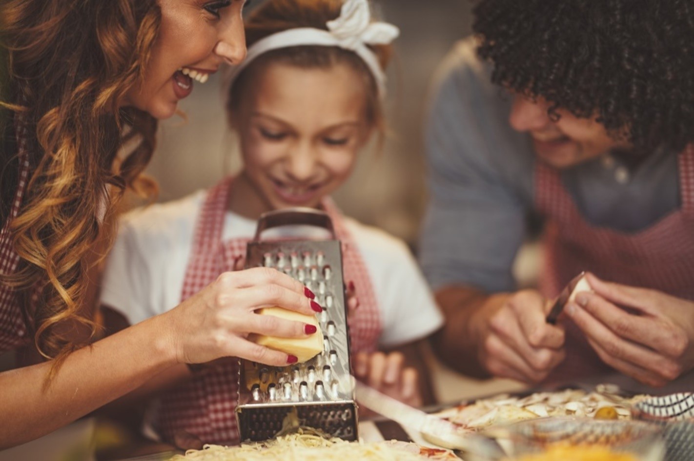 parents and child grating cheese