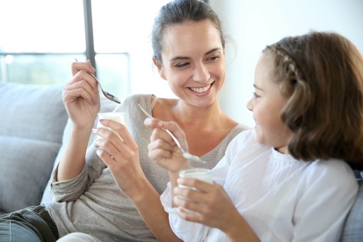 mom and daughter eating yogurt