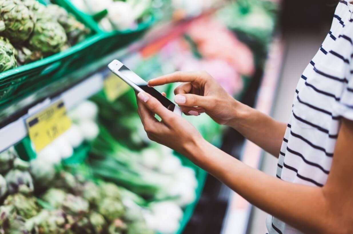 woman using phone in store