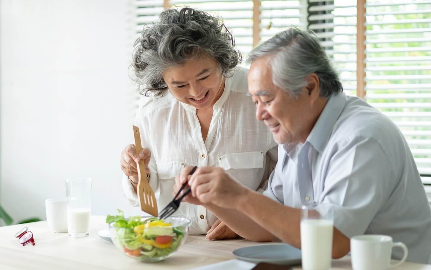 senior couple making salad