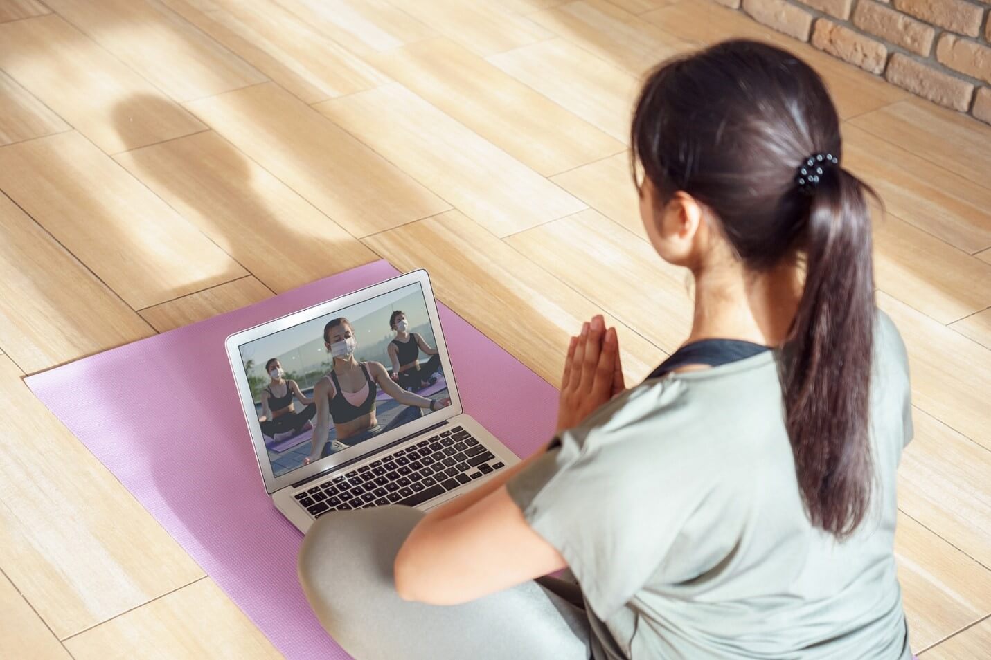 woman doing yoga on laptop