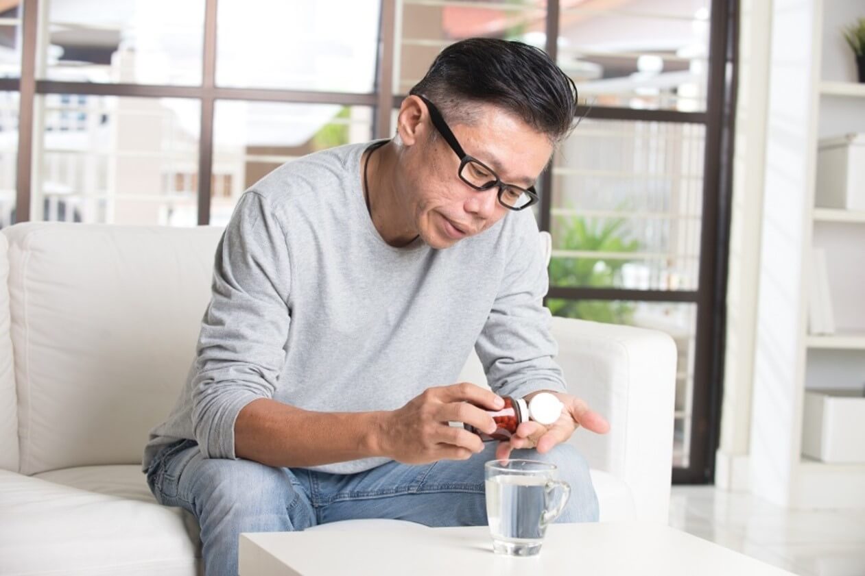 man taking supplements