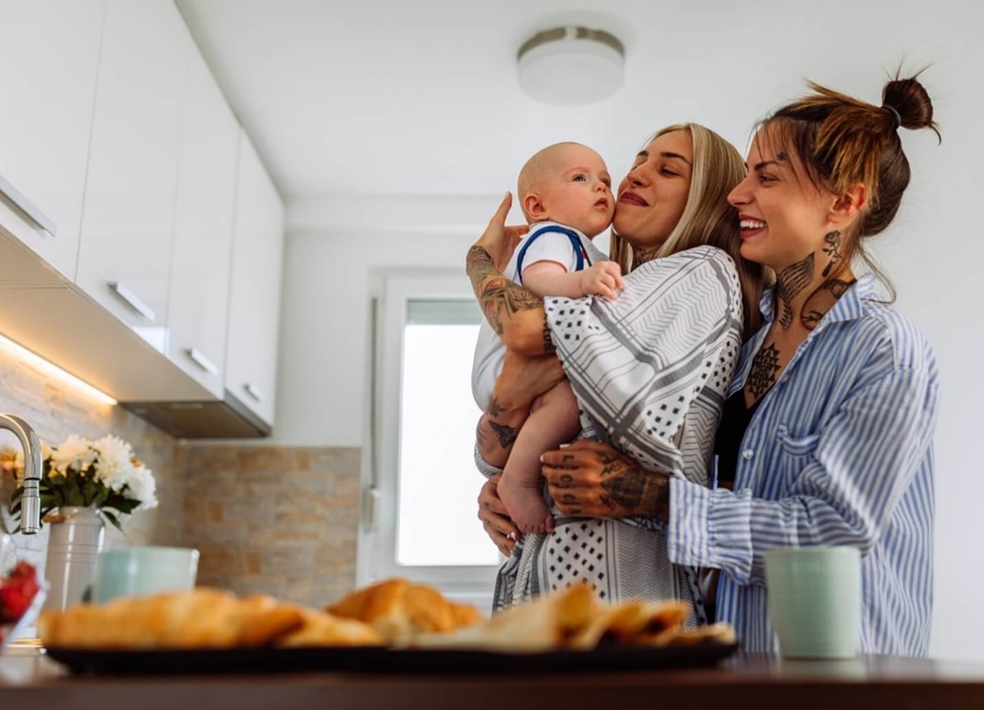 parents holding baby