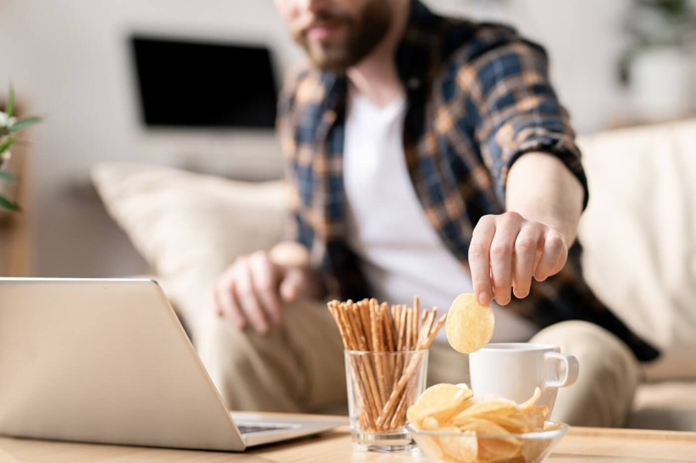 man reaching for snacks