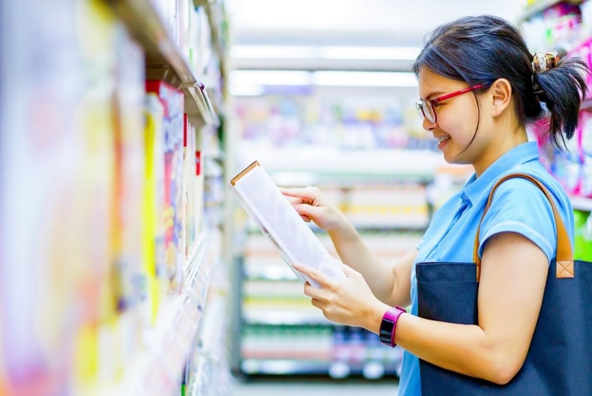 woman looking at box in store