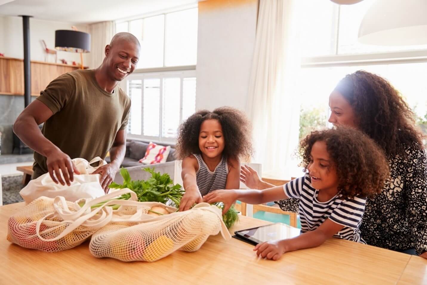 family reaching for veggies