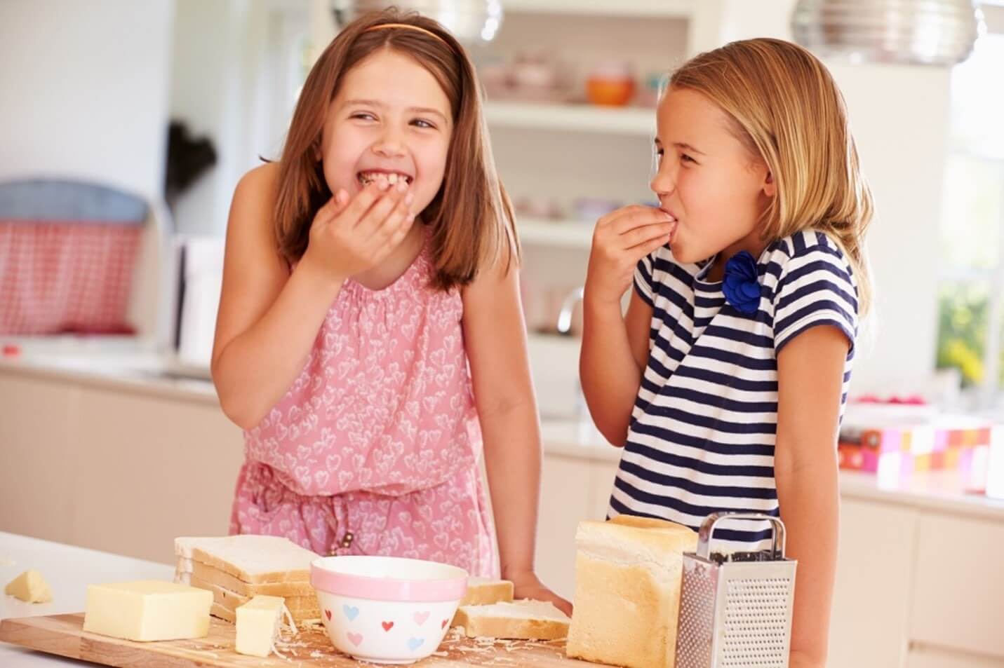 two kids eating cheese