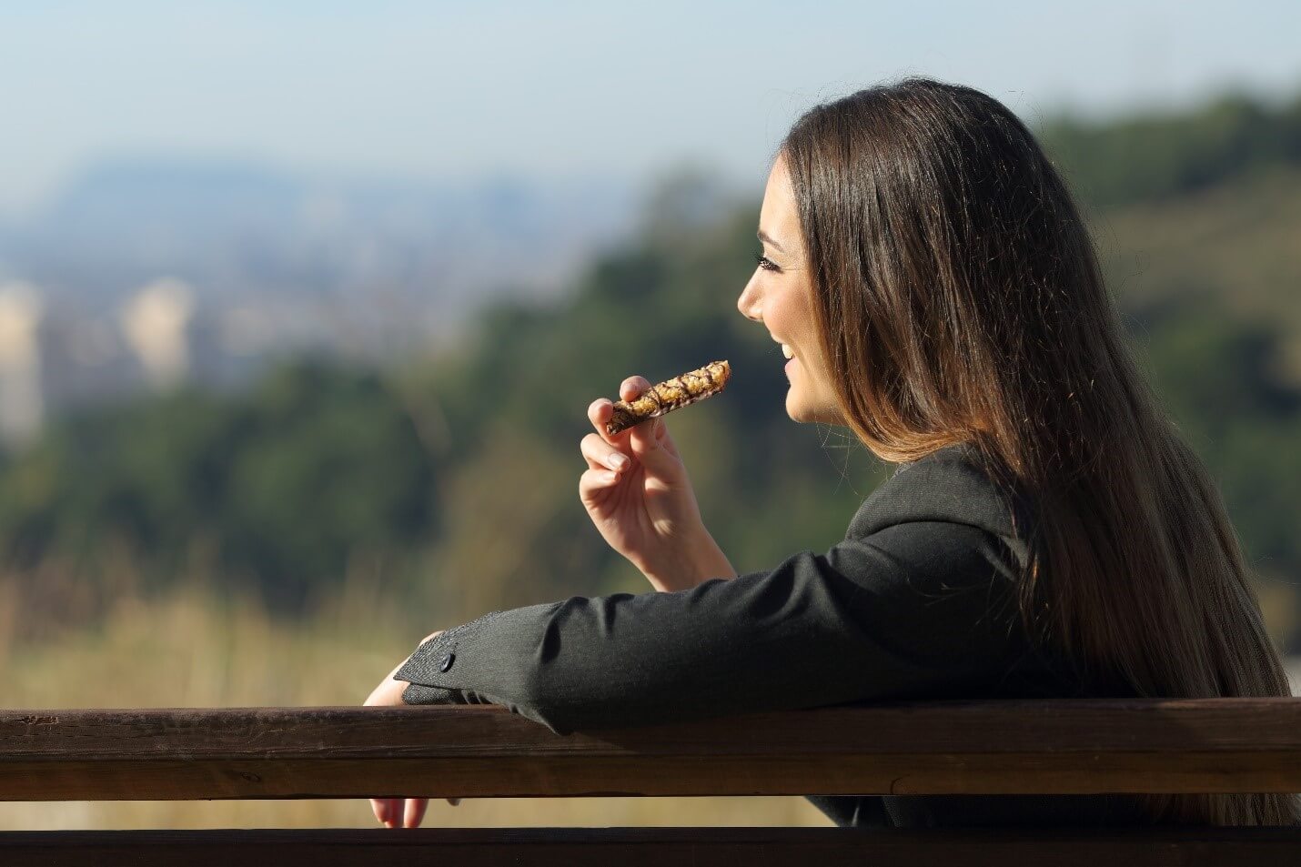 woman eating bar