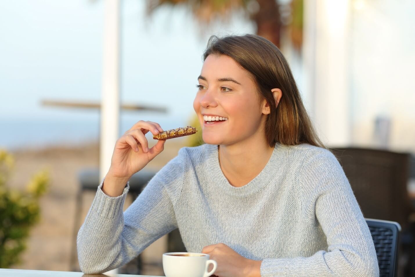 woman eating bar and coffee