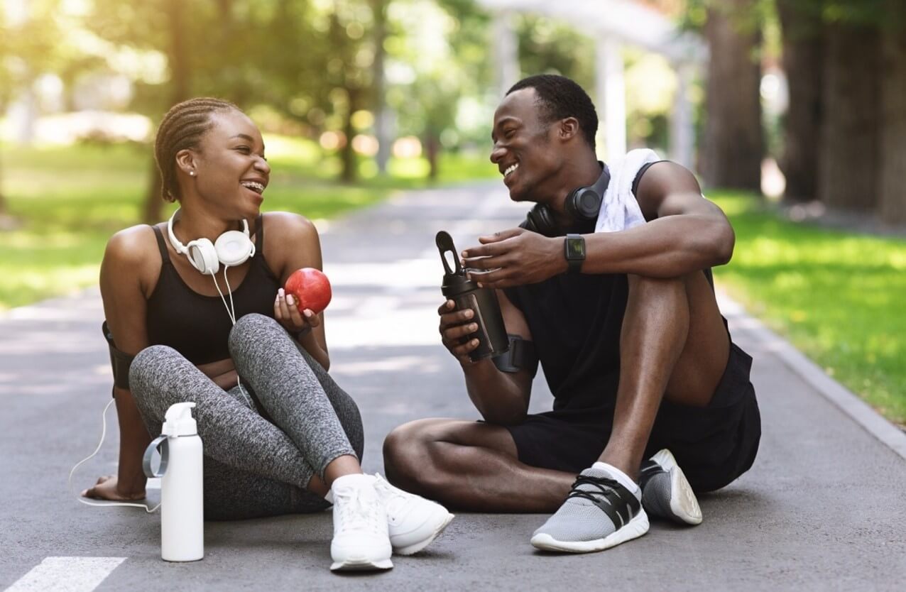 man and woman sitting after running 