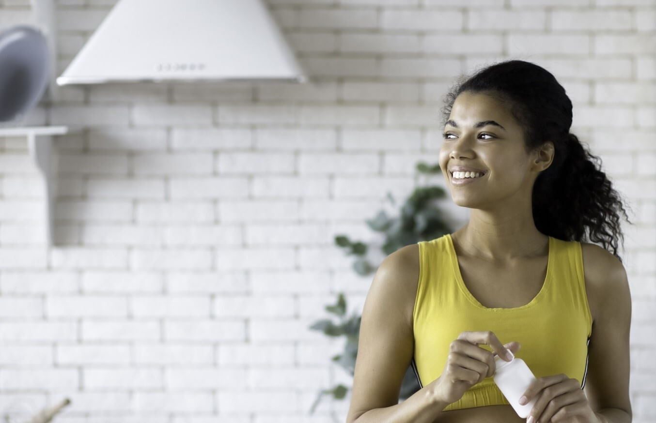 woman with supplement bottle