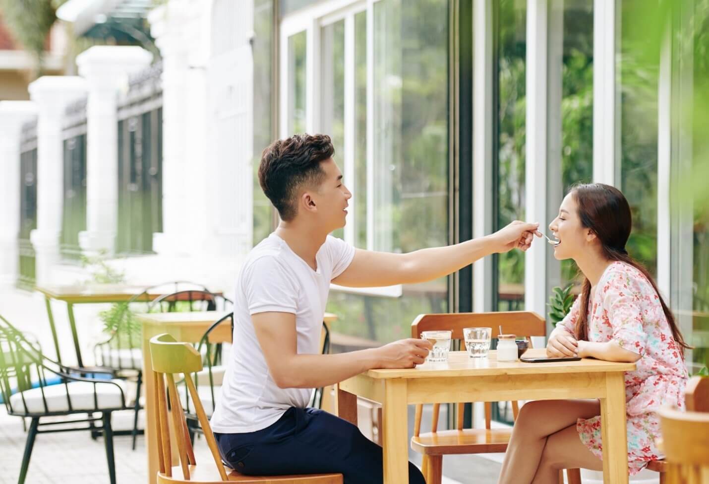 man feeding woman