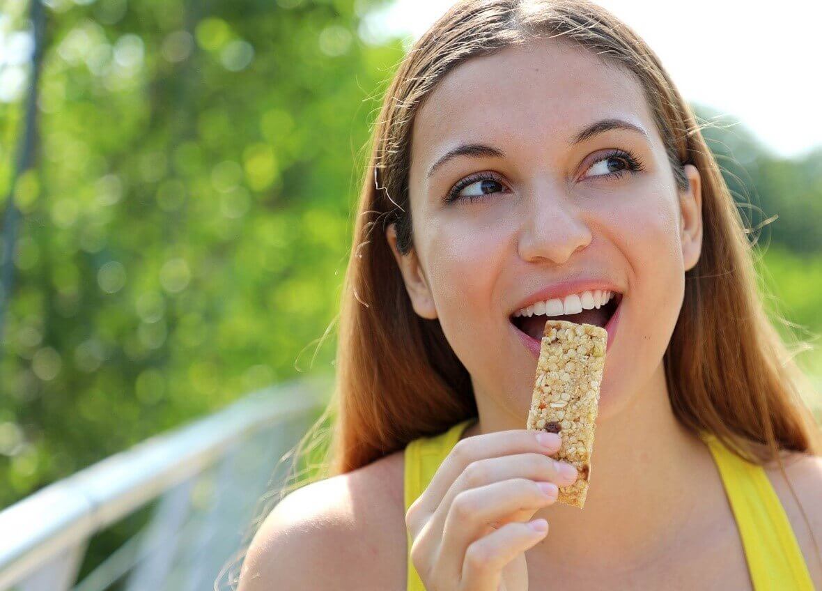 woman eating bar