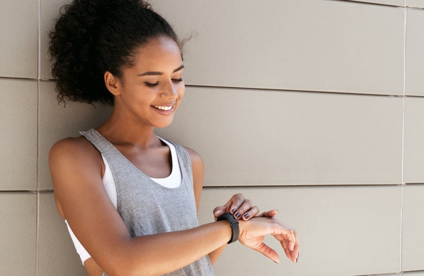 woman looking at fitness watch