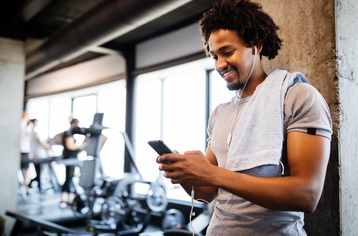 man looking at phone in gyn