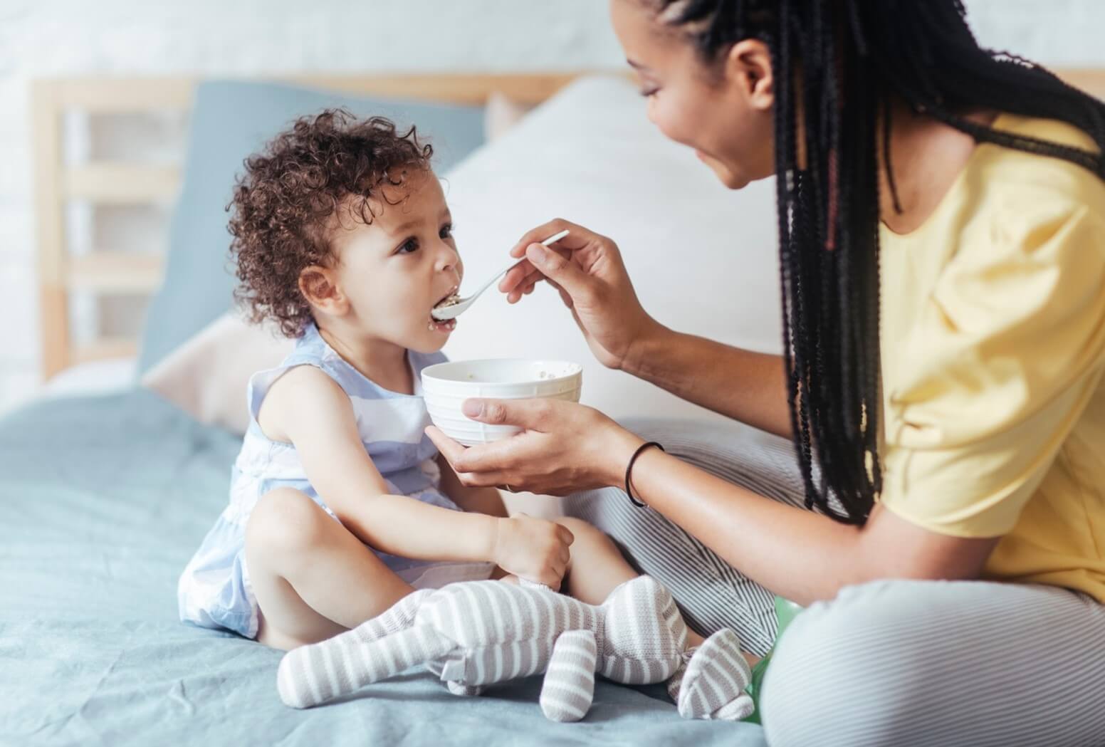 mom feeding toddler