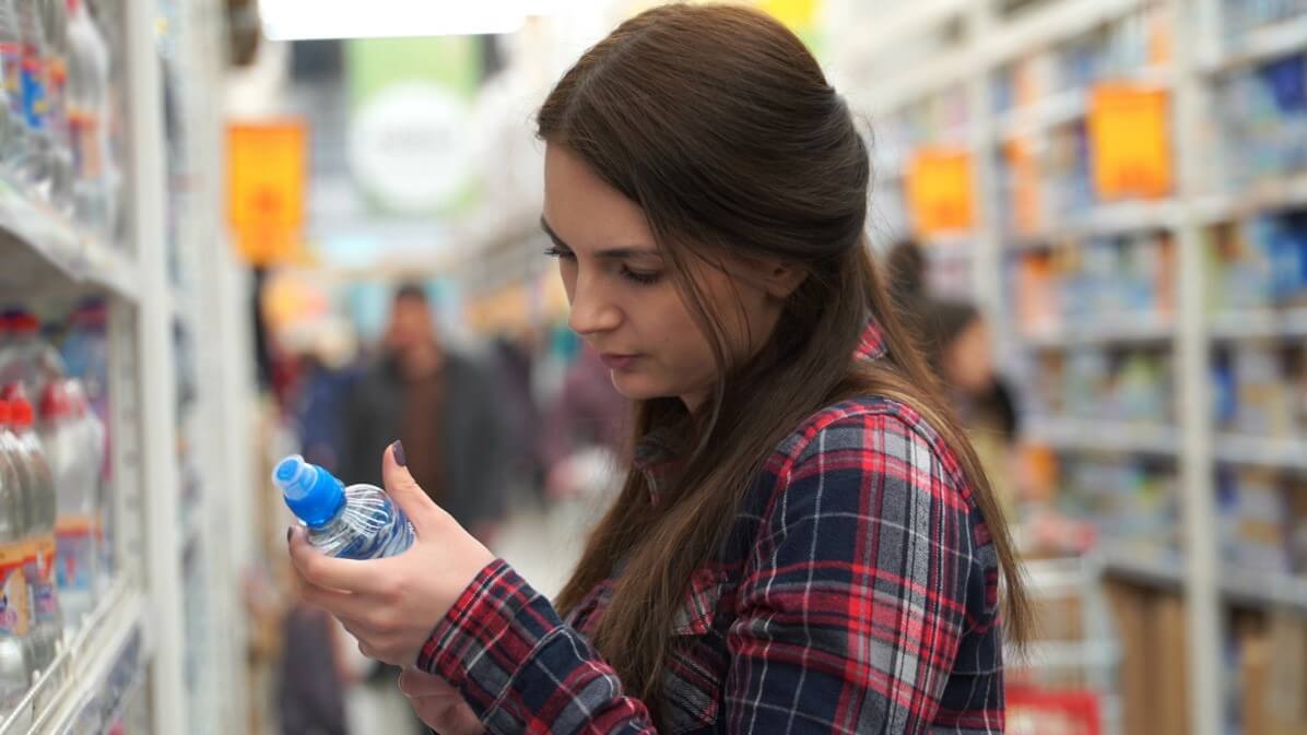 woman looking at water in store