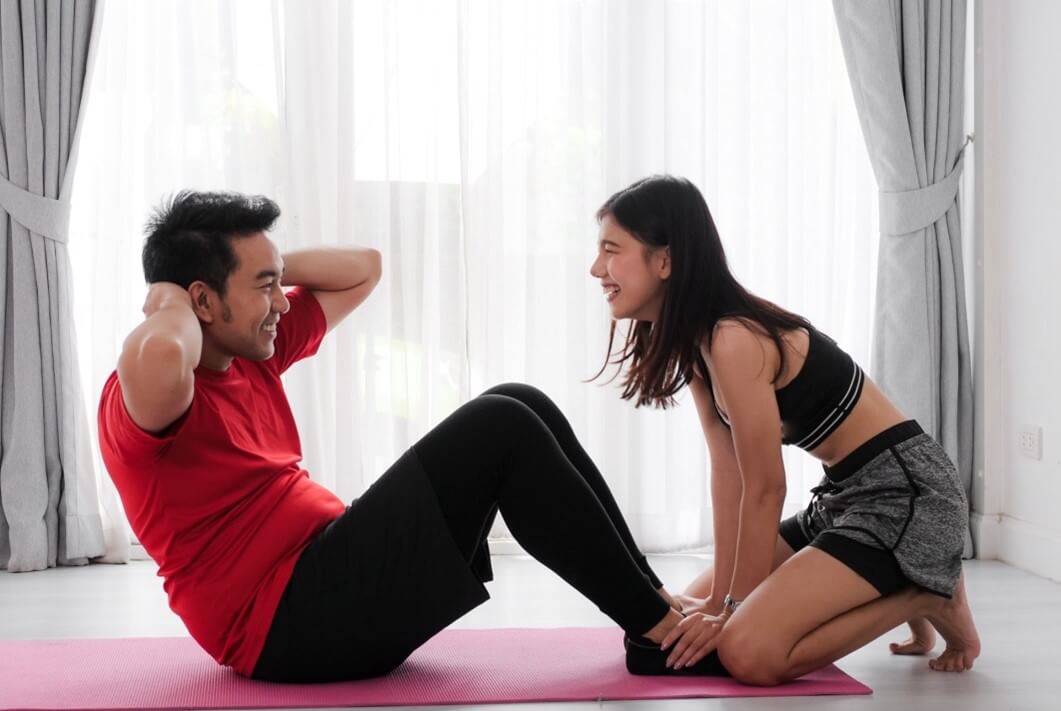 man and woman doing yoga