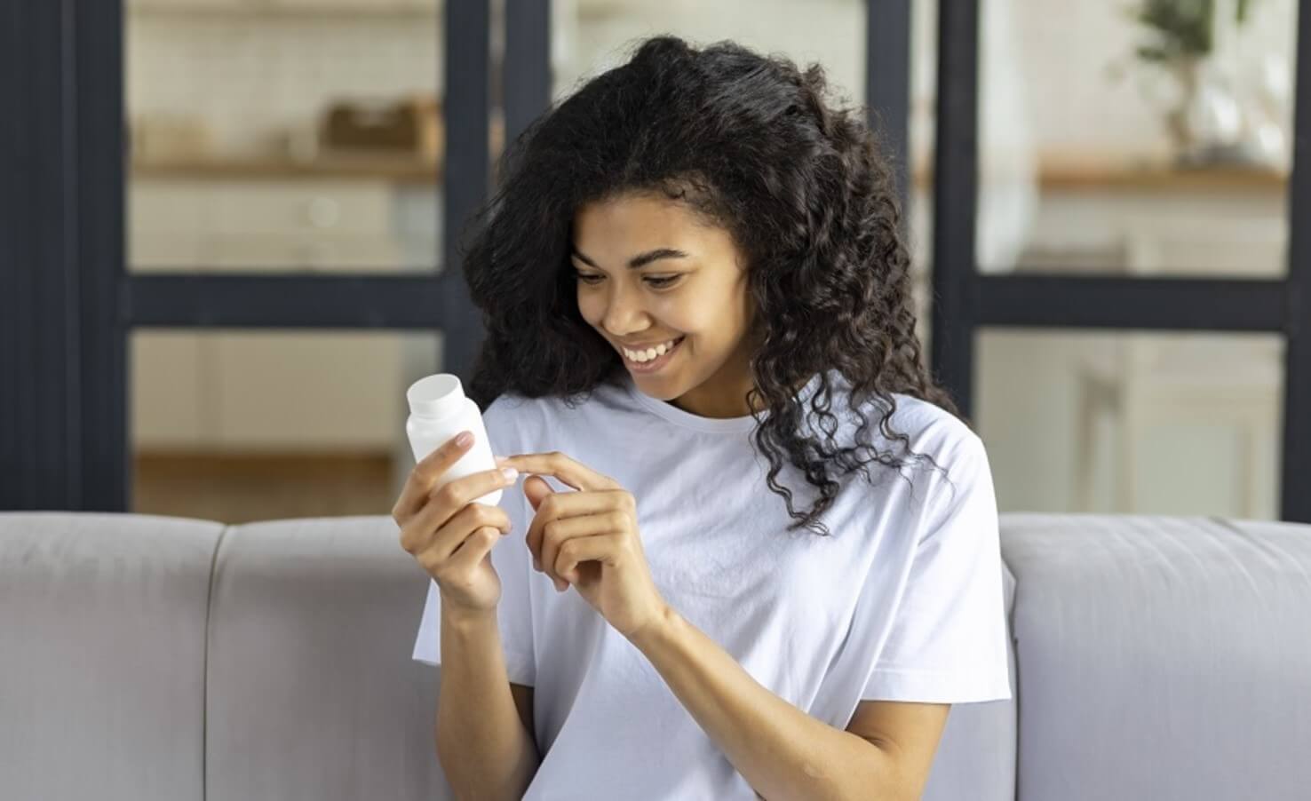 woman with supplement bottle