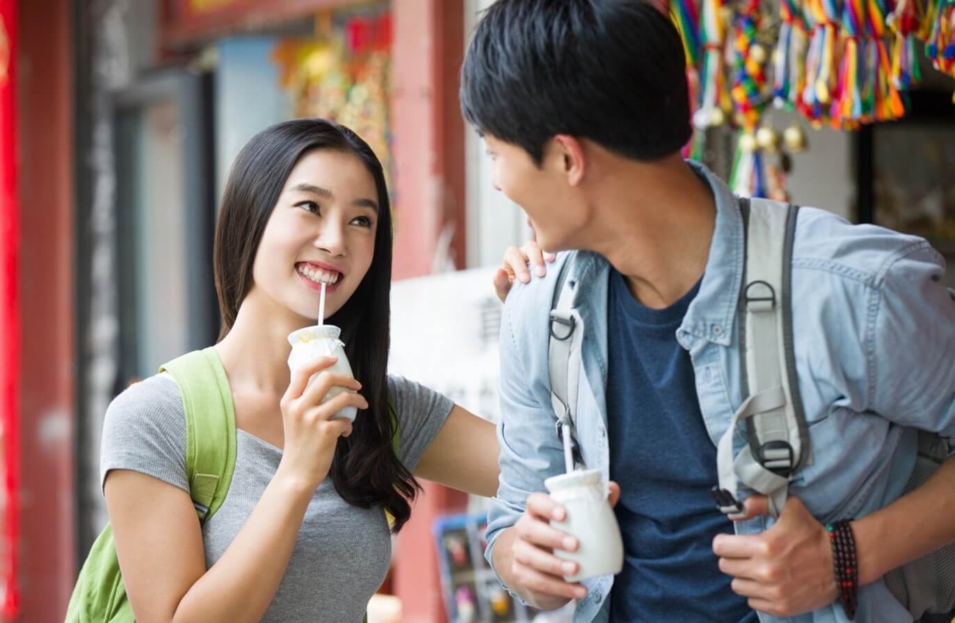 man and woman drinking beverage