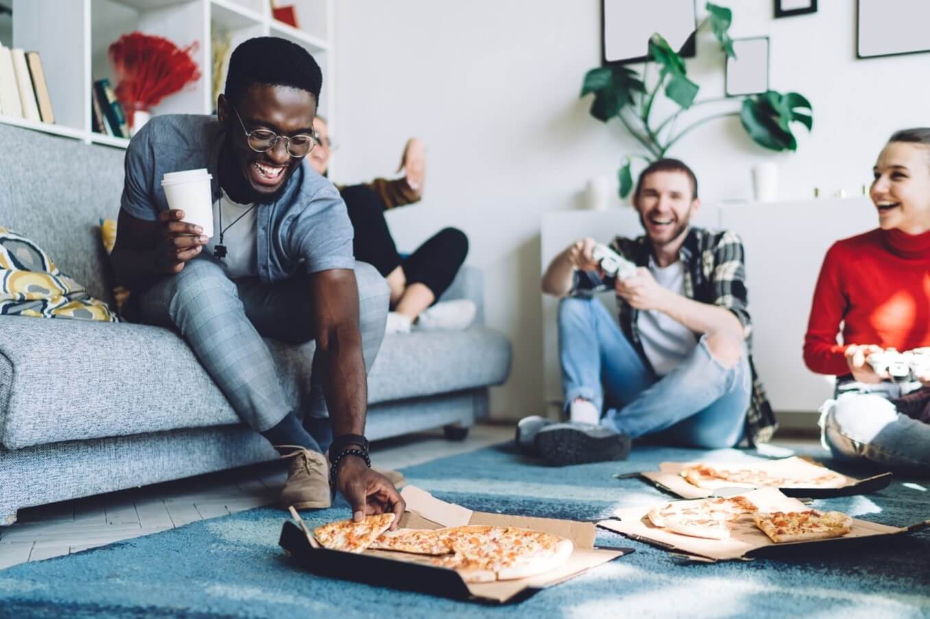 guy reaching for pizza