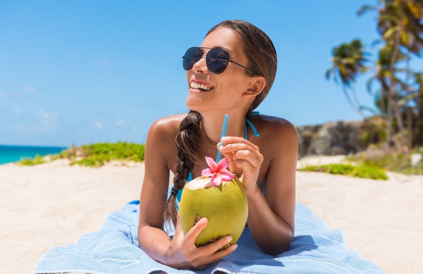 woman at the beach drinking beverage