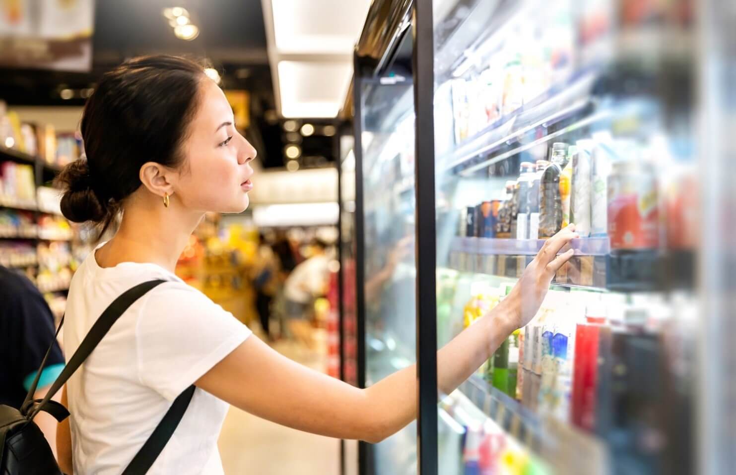 woman looking at beverages in store