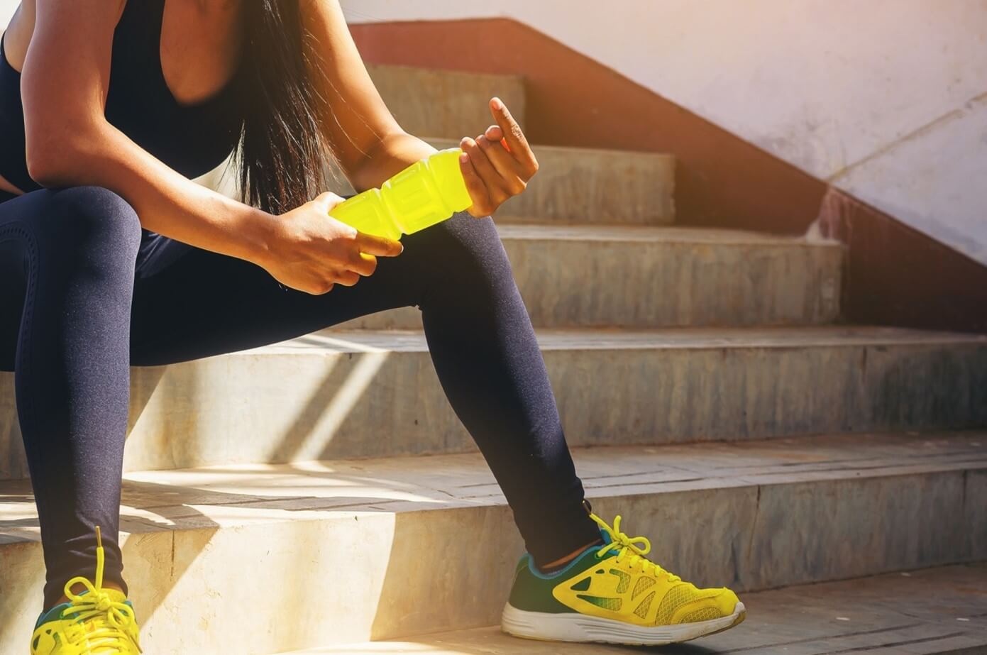 woman on stairs with functional beverage