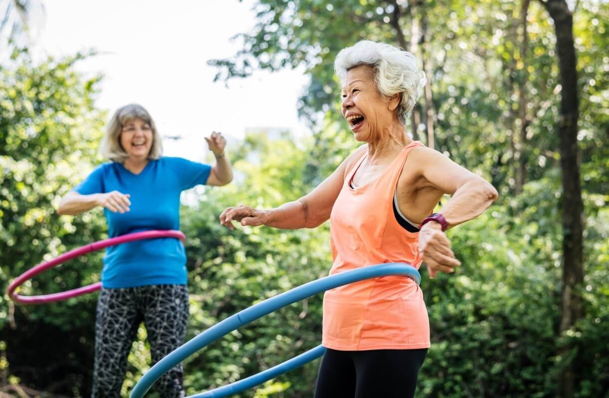 two asian seniors working out