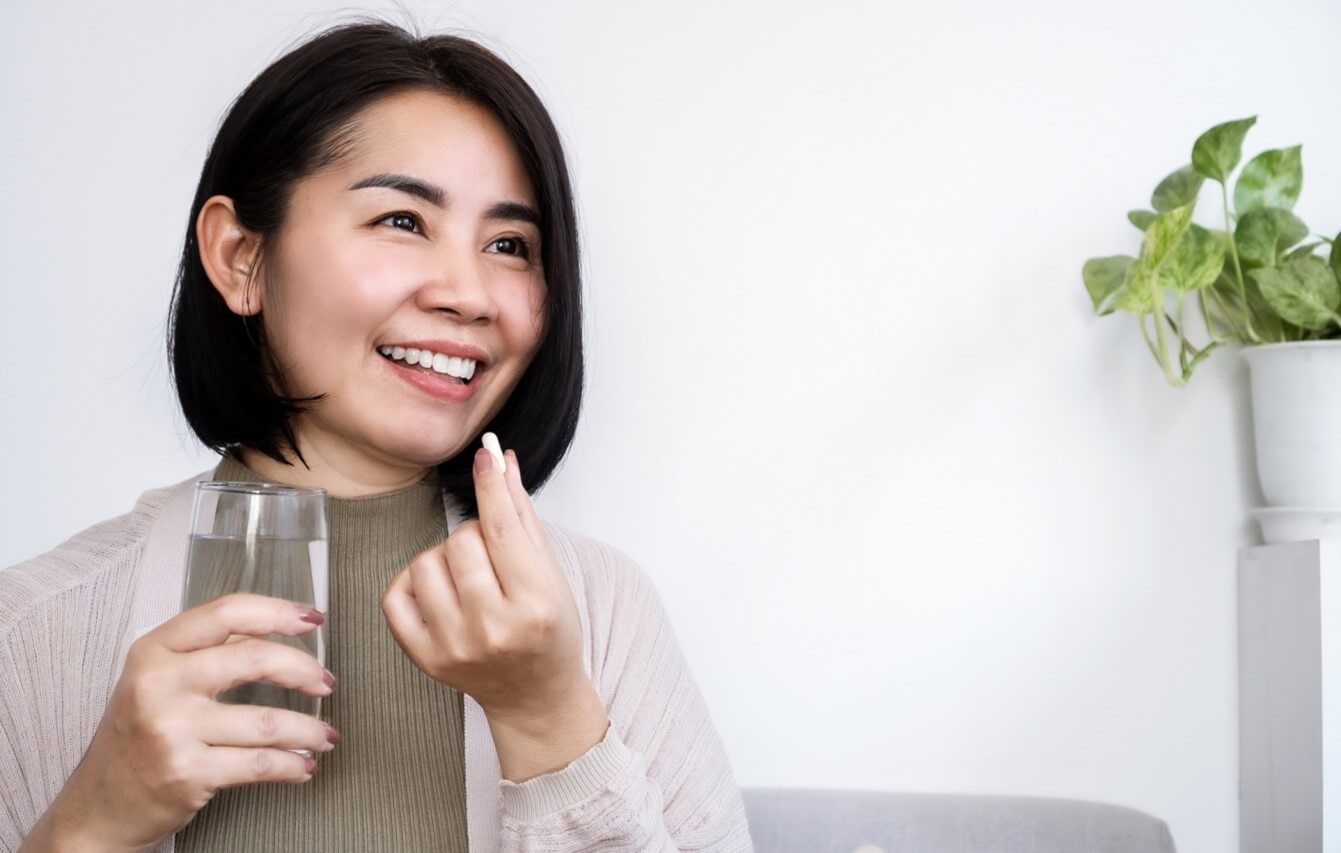 woman taking supplement