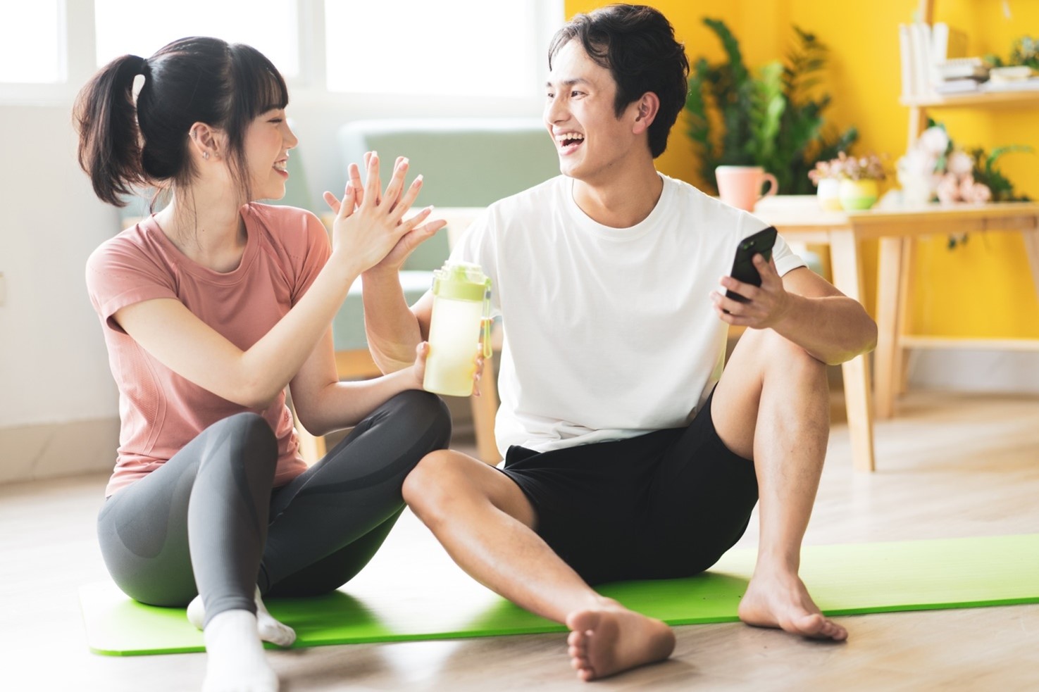 man and woman on yoga mat