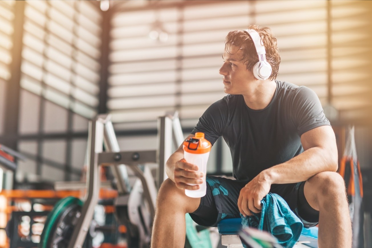 man with shaker bottle in gym