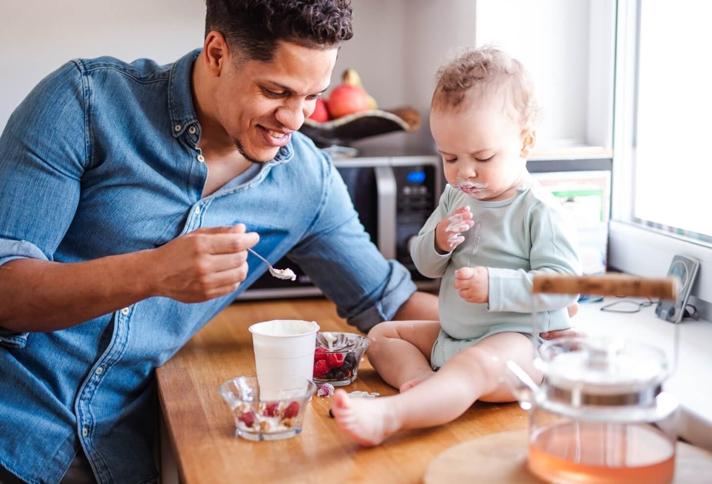 baby and dad eating yogurt