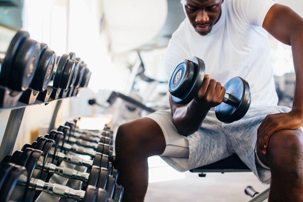 man lifting weight in gym