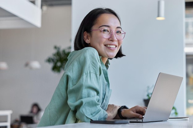 woman using computer smiling