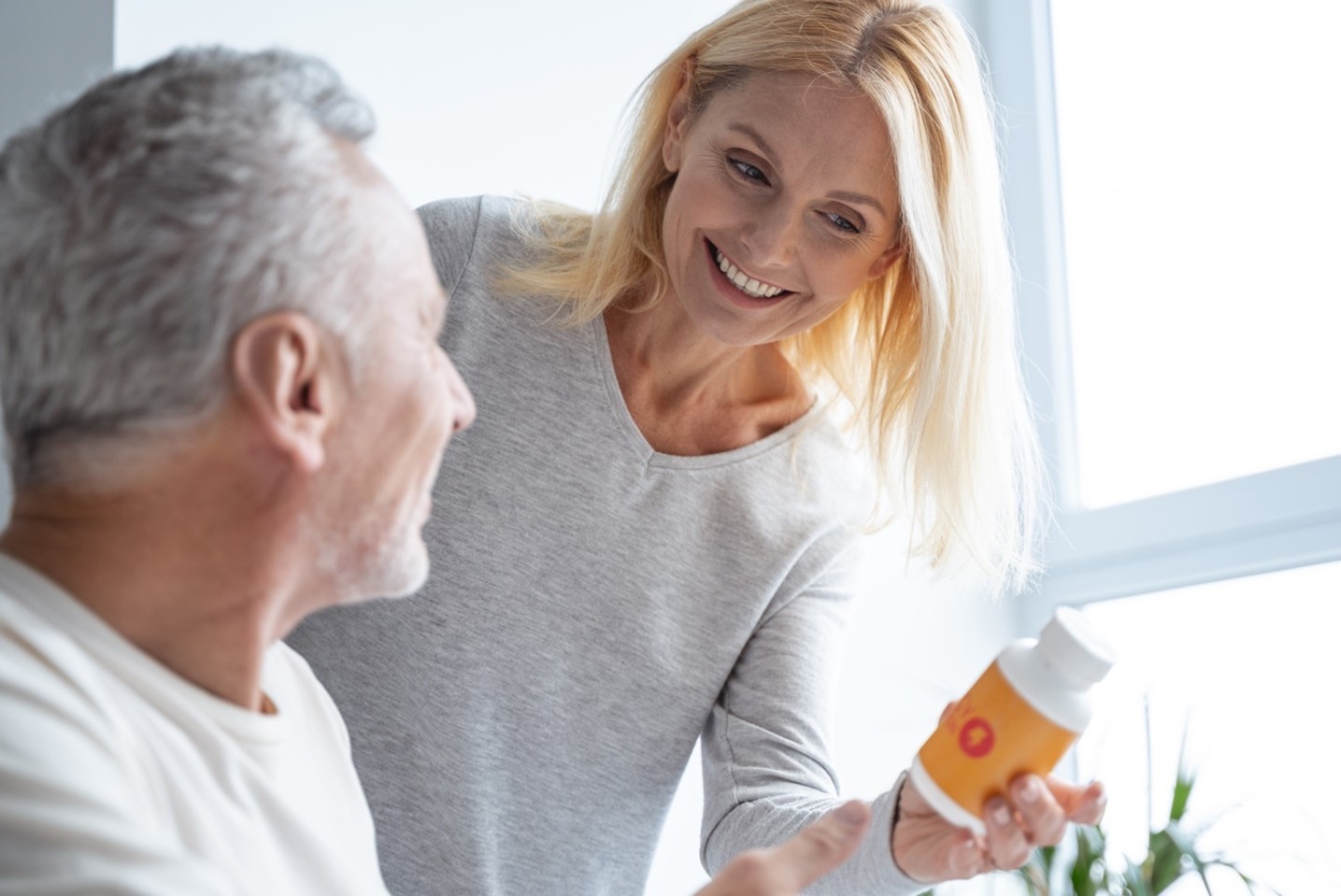 older lady holding supplement bottle